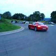 Red Porsche Cayman S drifting